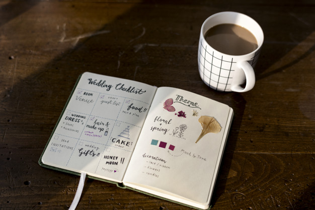 Closeup of wedding checklist notebook on wooden tabel
