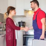 How to Hire the Right Professional Plumber for Your Home? Satisfied housewife handshaking after plumber quick service