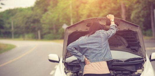 Women spection She opened the hood Broken car on the side See en