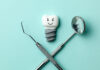 White teeth implants are smiling on green mint background and de